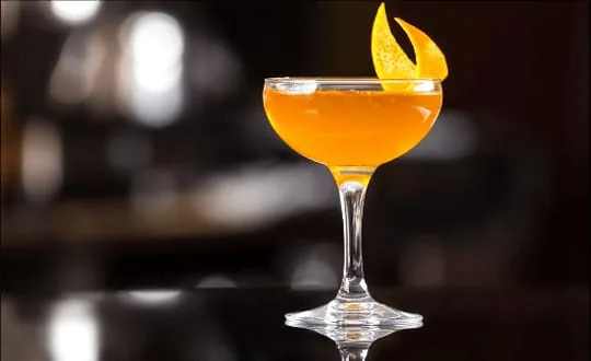 Coquetel laranja servido em taça coupe